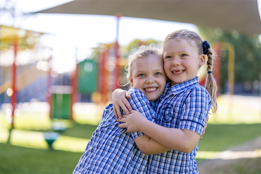 Two students playing in the playground 