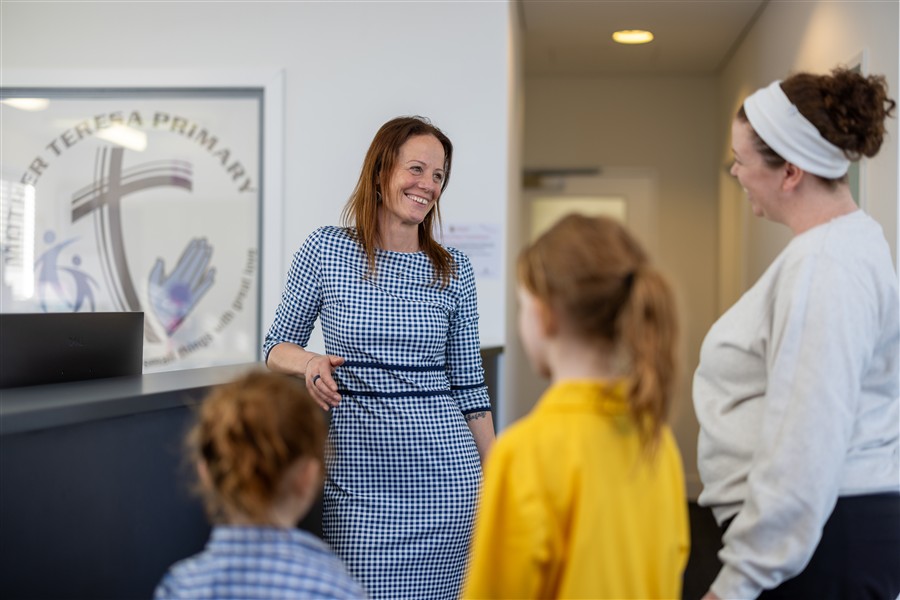 Principal greeting Parent and students in administration office 